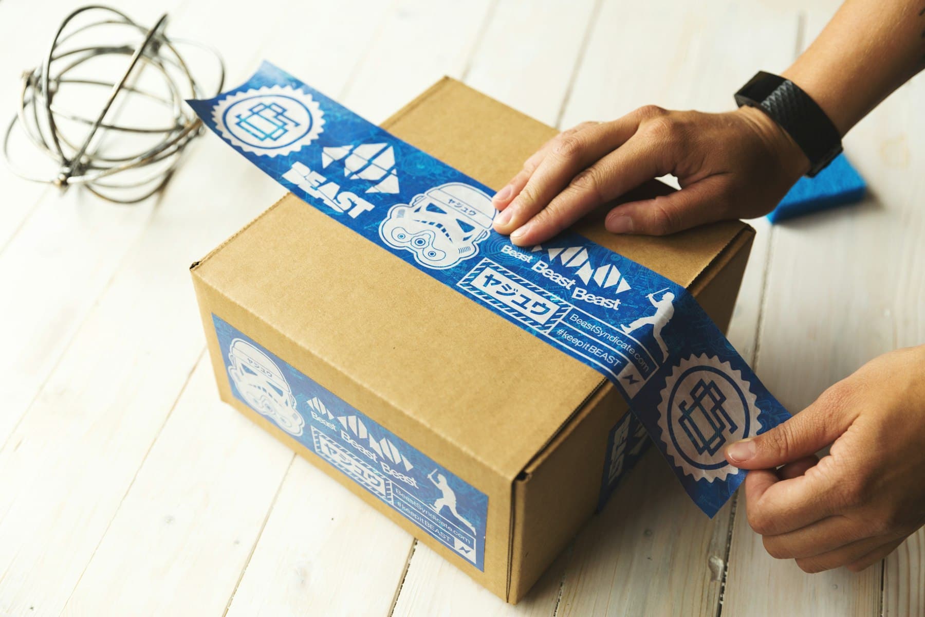 Hands packing a parcel for dispatch