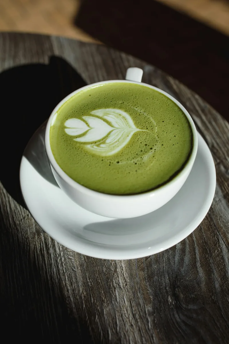 A matcha latte with latte art served in a café